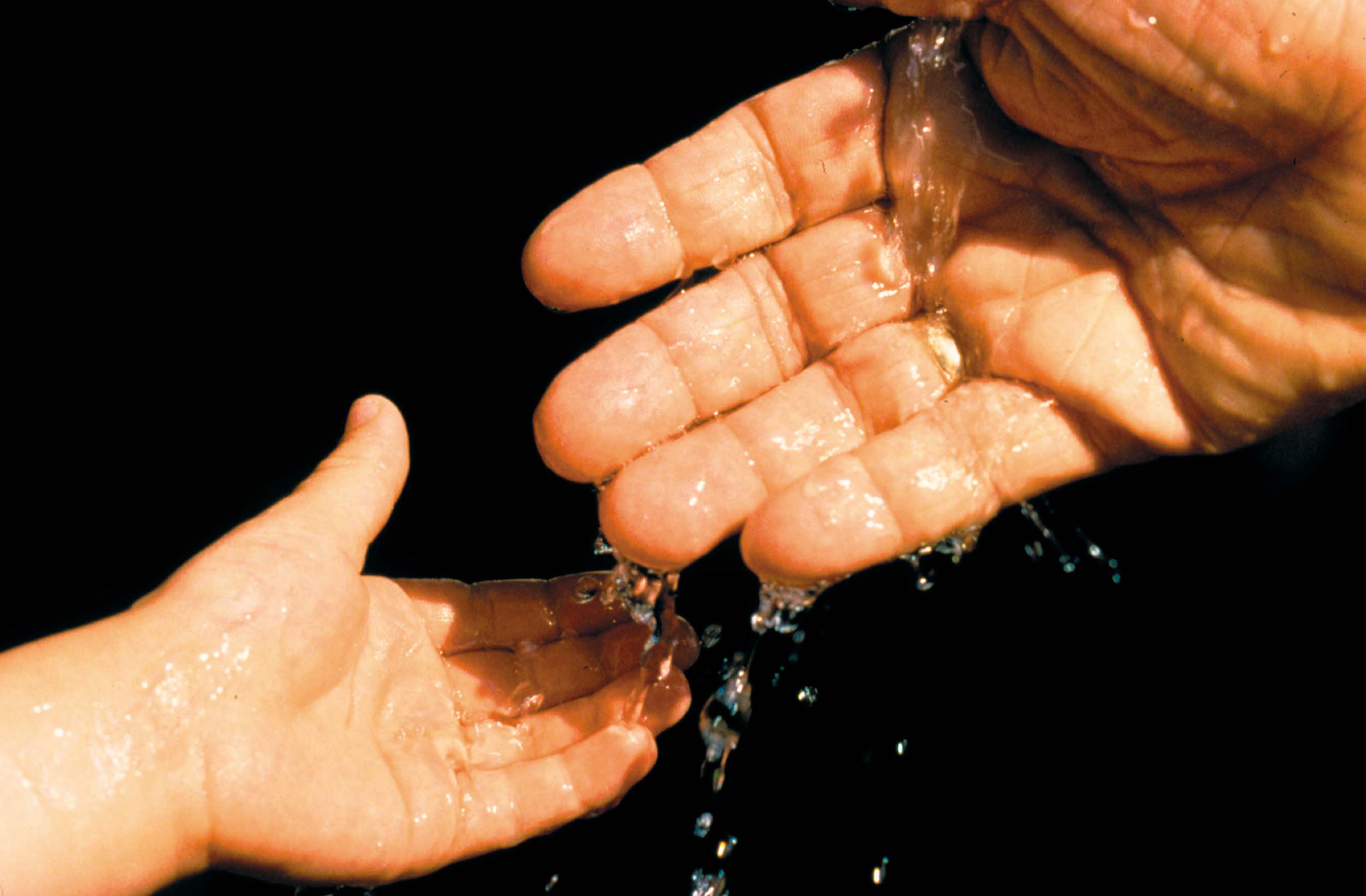 l_adult_hands_water_to_child